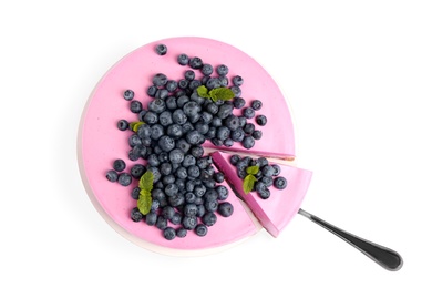 Cut tasty blueberry cake and shovel on white background, top view