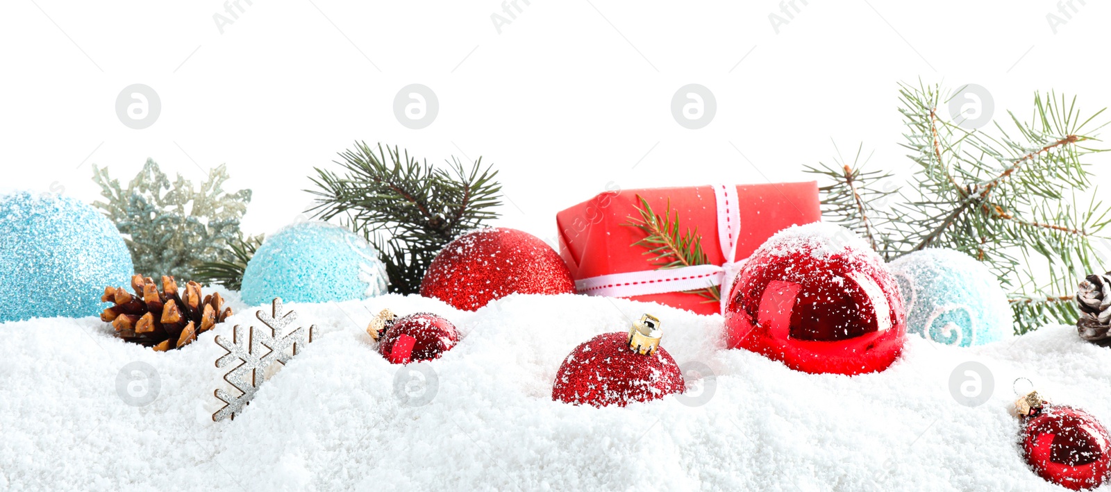 Photo of Christmas decoration on snow against white background