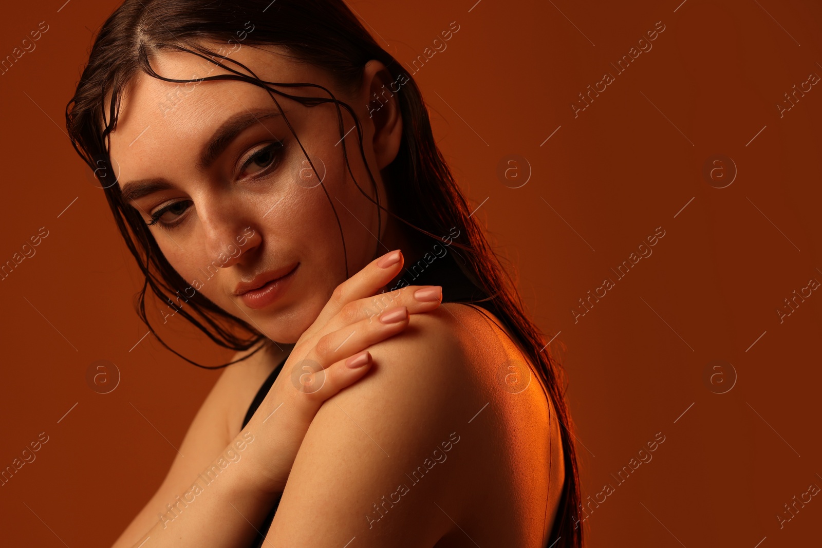 Photo of Portrait of beautiful woman on brown background. Space for text