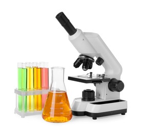 Laboratory glassware with colorful liquids and microscope isolated on white