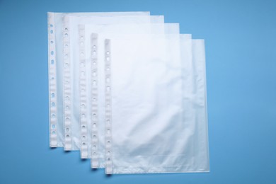 Photo of Punched pockets on light blue background, flat lay