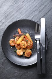 Delicious fried scallops served on dark gray textured table, top view