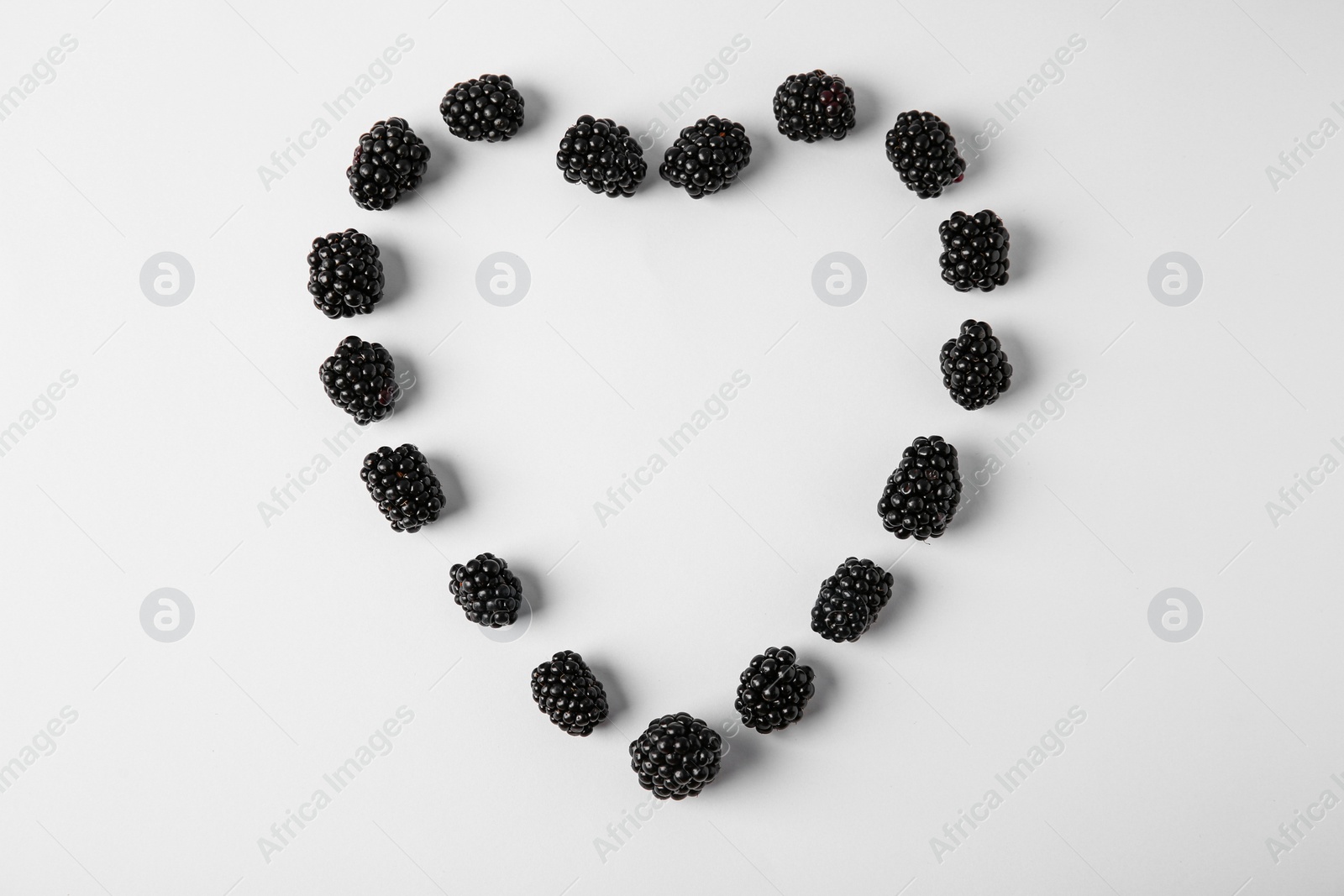 Photo of Composition with ripe blackberries on white background, top view. Space for text
