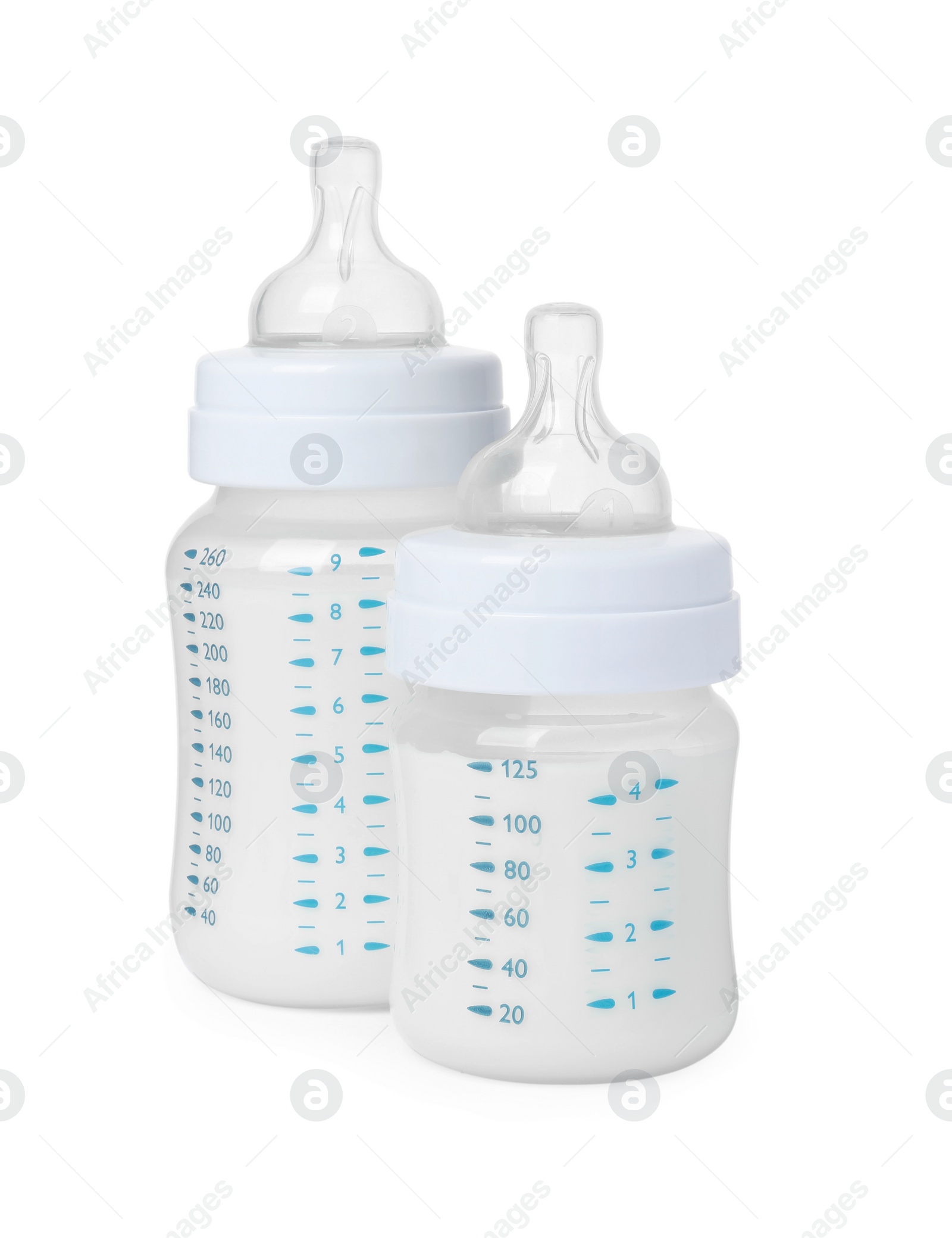 Photo of Two feeding bottles with infant formula on white background