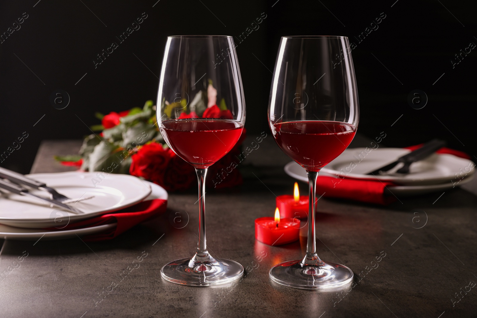 Photo of Beautiful place setting for romantic dinner on grey table