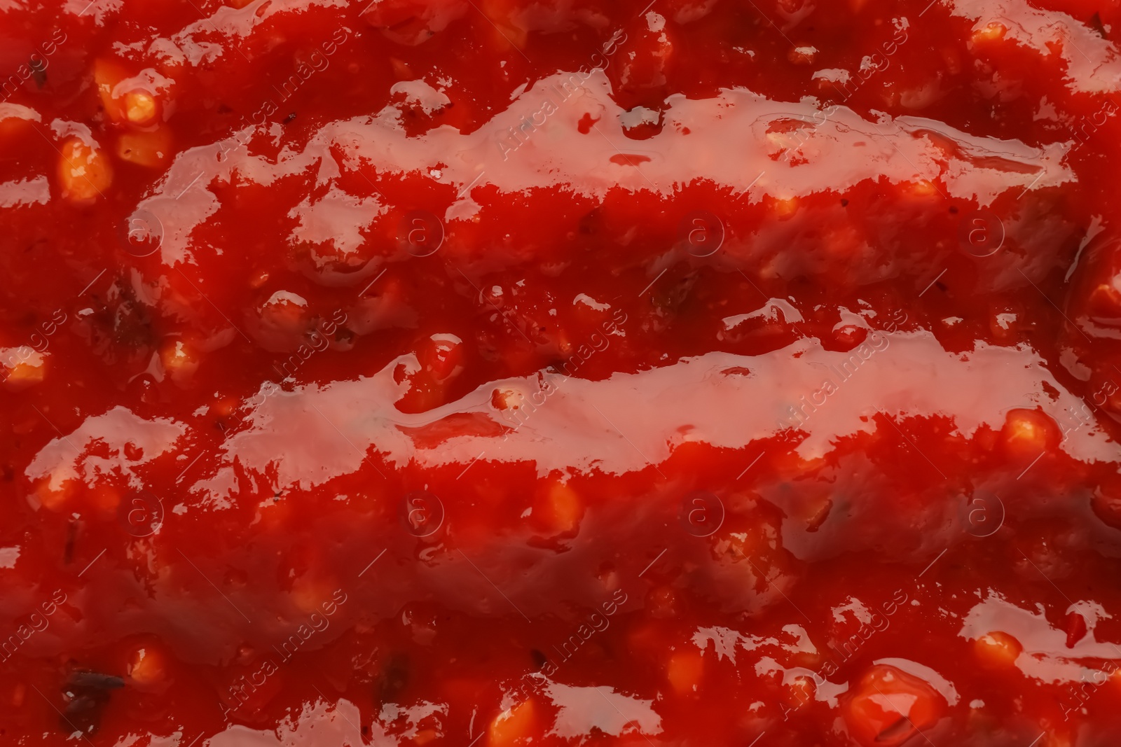 Photo of Texture of delicious adjika sauce as background, closeup