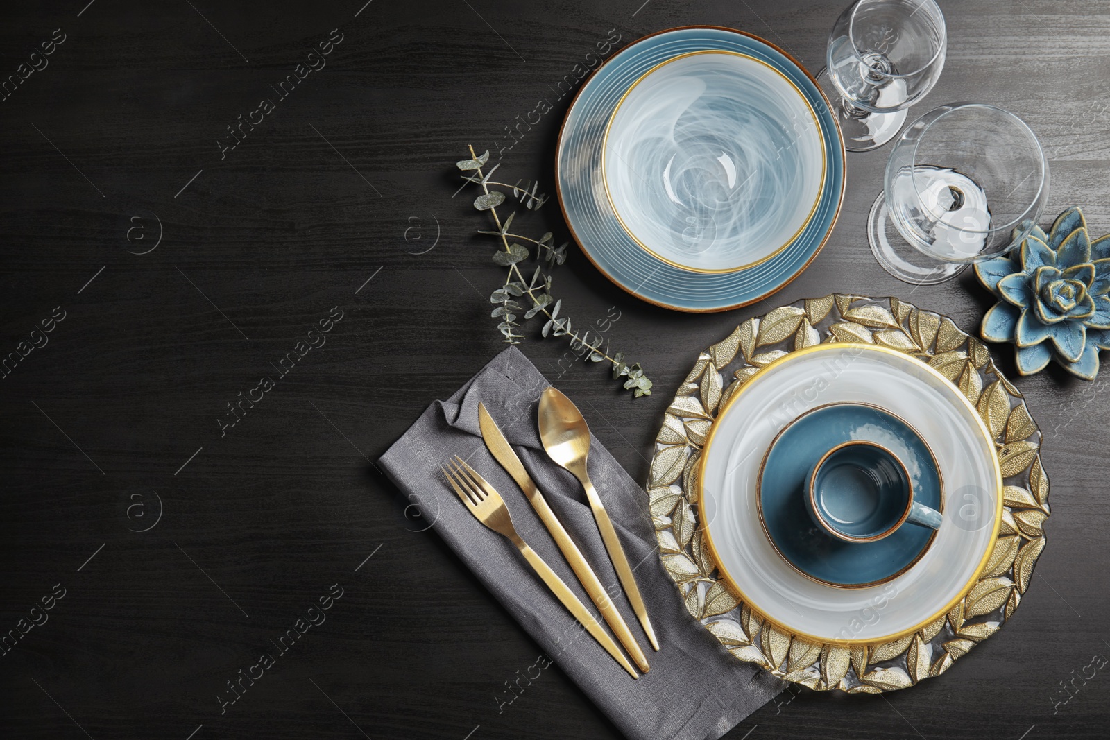 Photo of Elegant table setting and space for text on dark background, top view