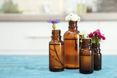 Composition with essential oils and flowers on table