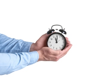 Young man holding alarm clock on white background. Time concept