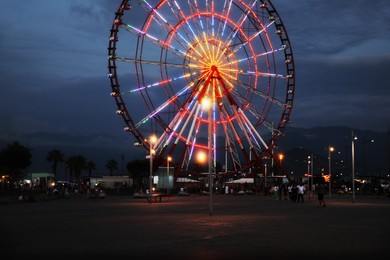 Photo of Beautiful glowing Ferris wheel in amusement park