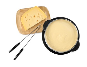 Photo of Fondue with tasty melted cheese, forks and piece isolated on white, top view