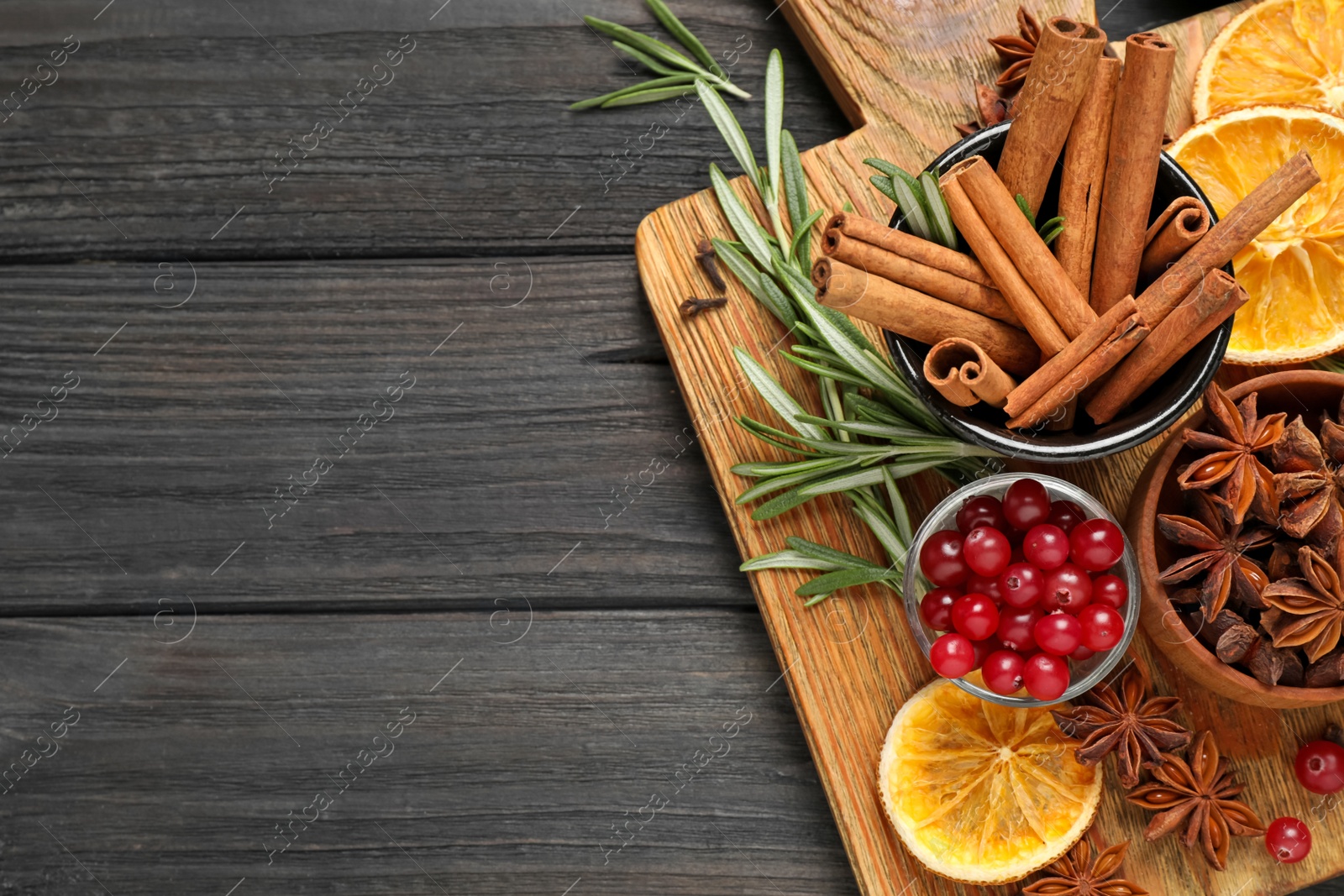 Photo of Flat lay composition with mulled wine ingredients on black wooden table. Space for text