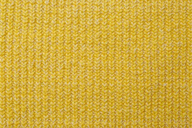 Yellow knitted fabric as background, top view