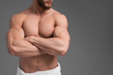 Photo of Muscular man on grey background, closeup and space for text. Sexy body
