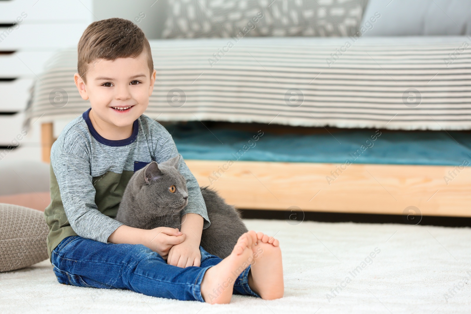 Photo of Cute little child with cat at home