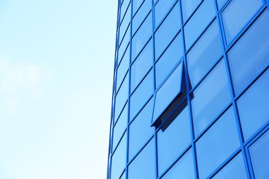 Modern office building with tinted windows against blue sky