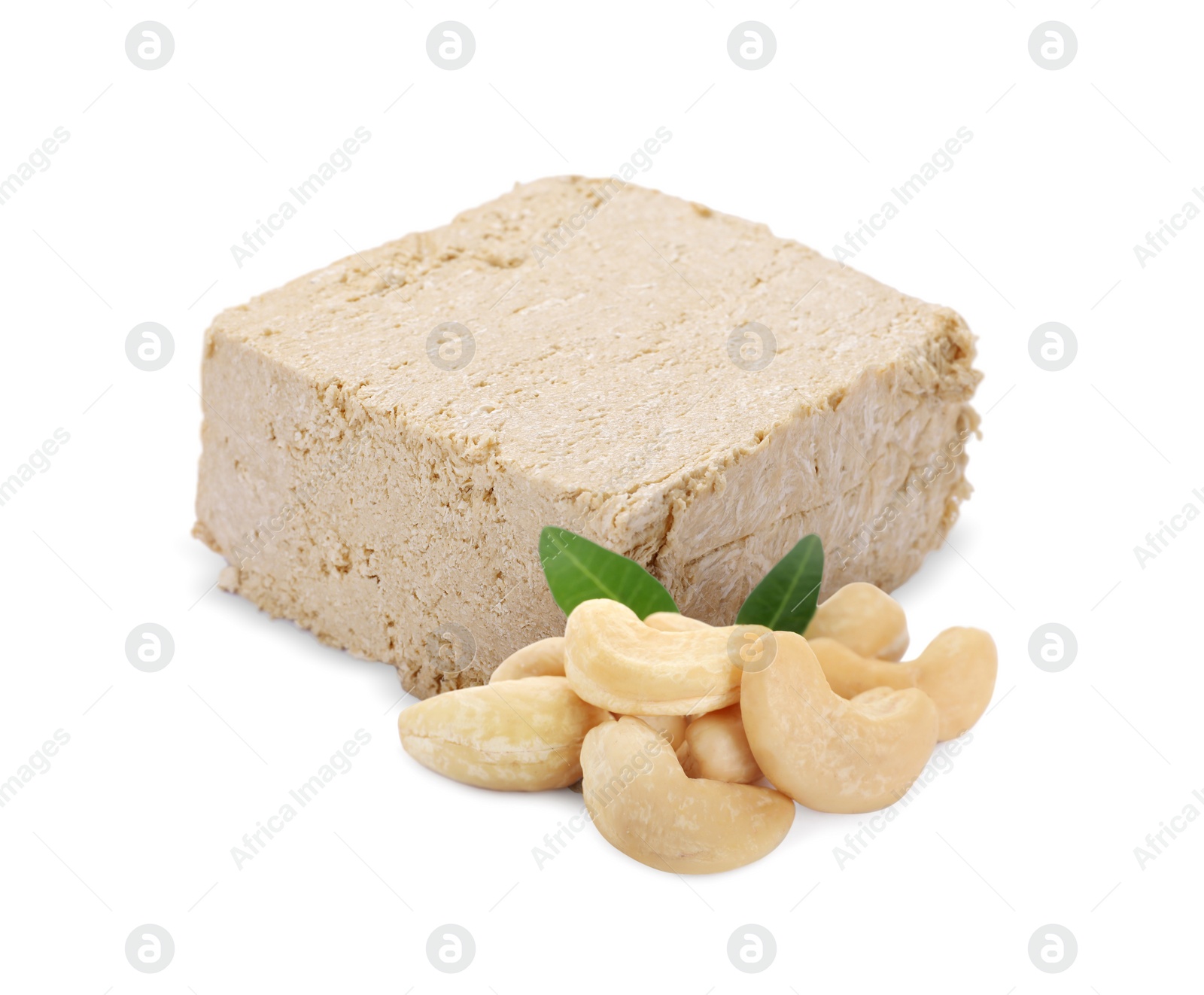 Image of Tasty halva, cashew nuts and green leaves isolated on white