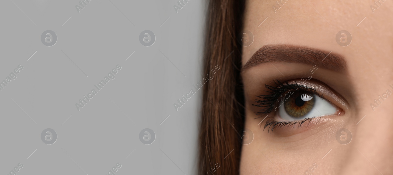 Image of Closeup view of woman with beautiful eyes on light grey background, space for text. Banner design