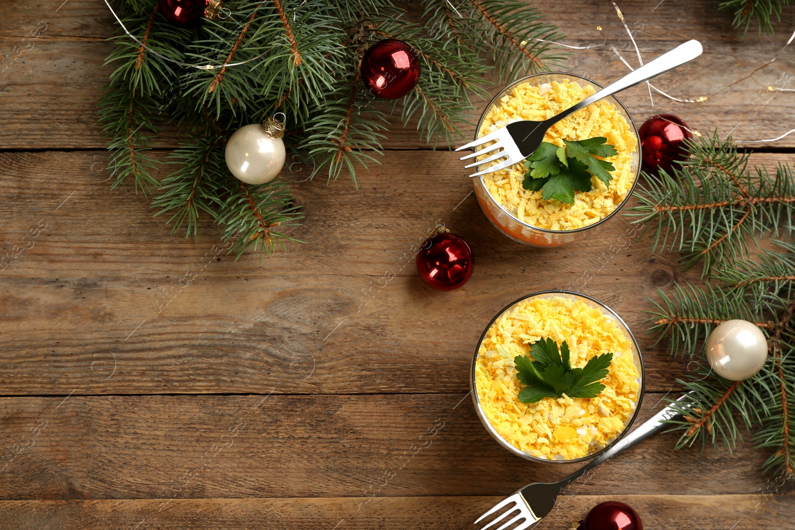 Photo of Flat lay composition with traditional russian salad Mimosa on wooden table, space for text