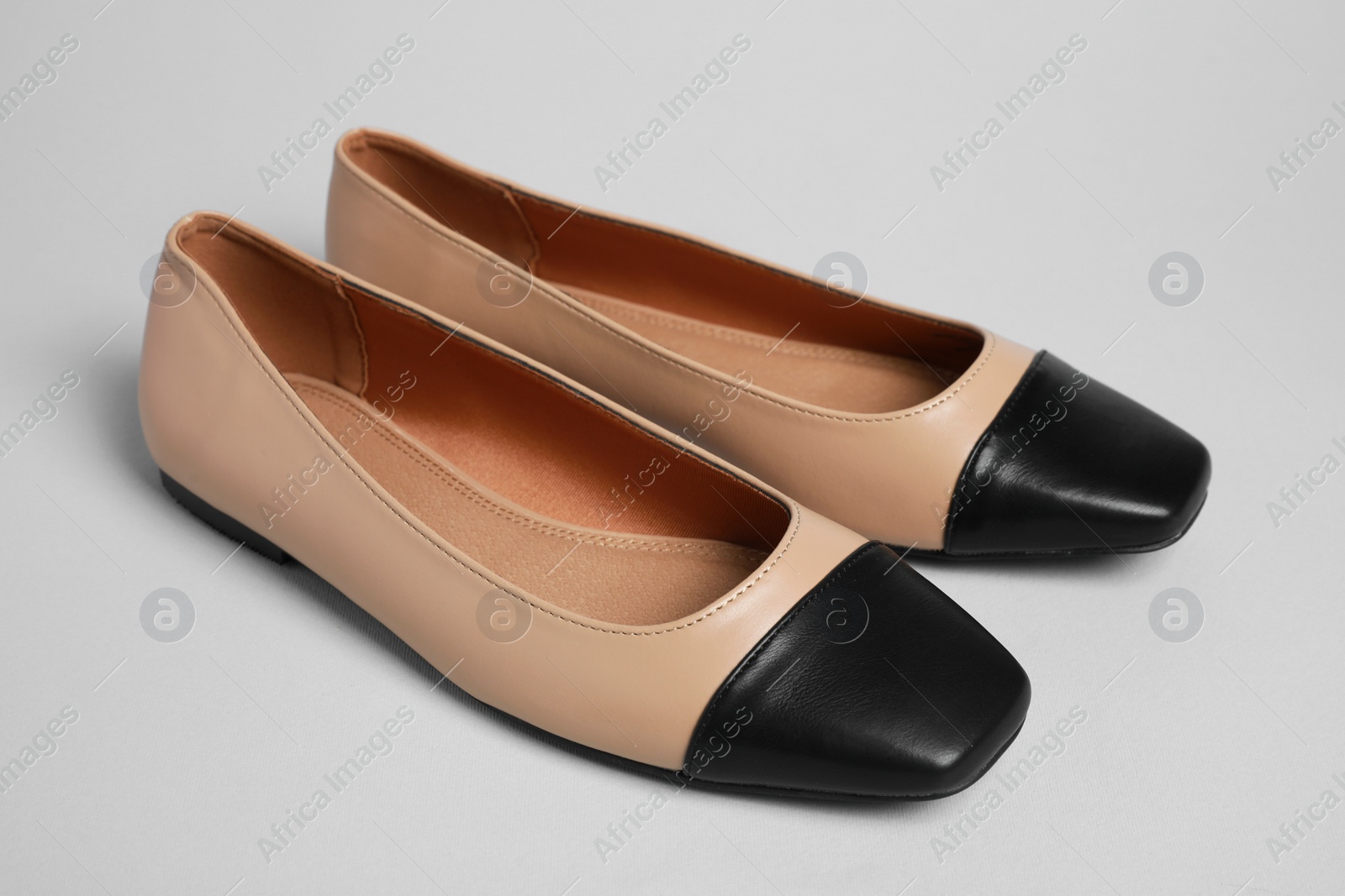 Photo of Pair of new stylish square toe ballet flats on light grey background