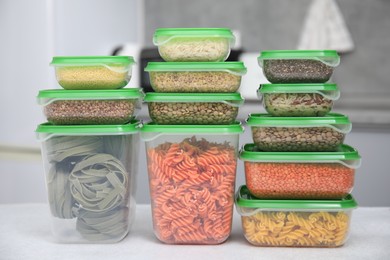 Photo of Plastic containers filled with food products on light table indoors