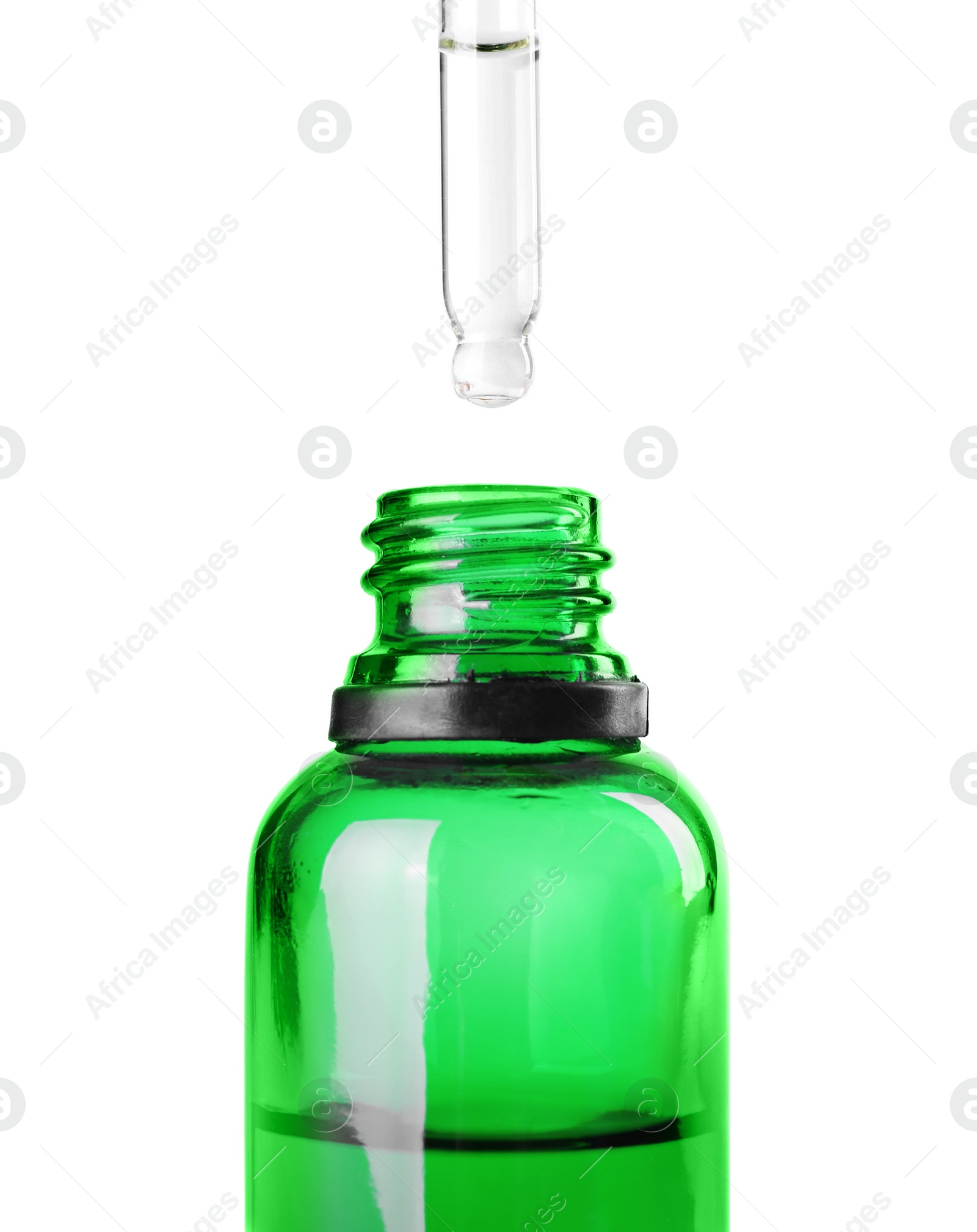 Photo of Dropping herbal essential oil into bottle isolated on white