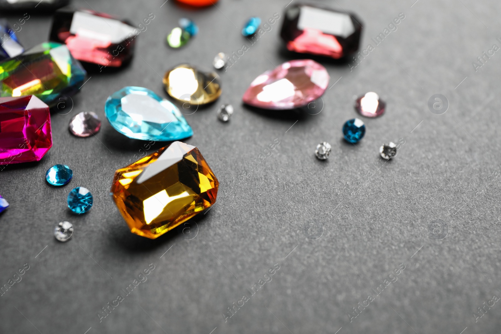 Photo of Different beautiful bright gemstones on black background