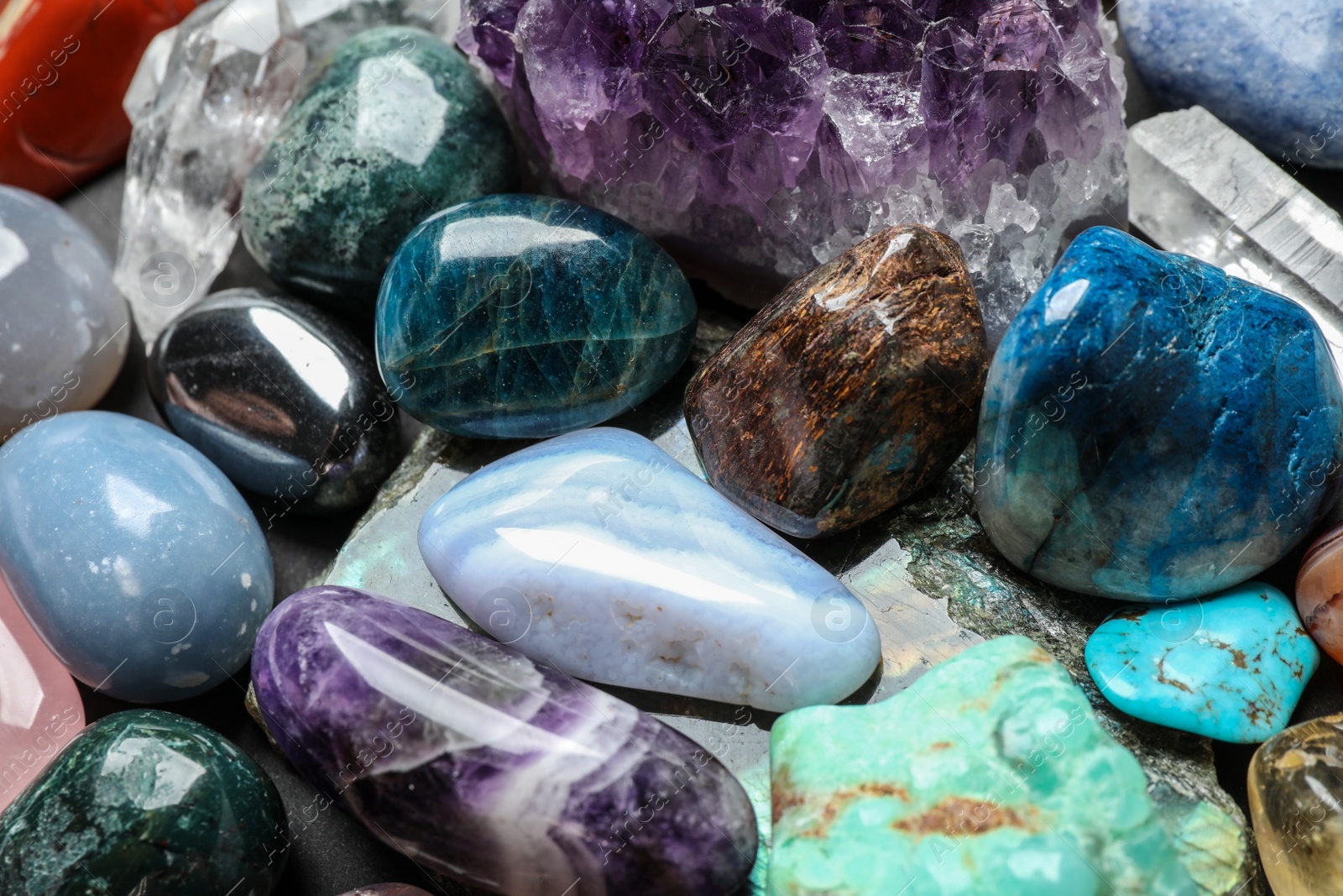 Photo of Different precious gemstones as background, closeup view