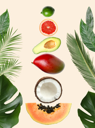 Image of Tropical layout with fresh exotic fruits and green leaves on pale beige background, top view