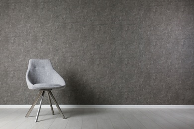 Photo of Grey modern chair for interior design on wooden floor at gray wall