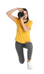 Photo of Young female photographer with camera on white background
