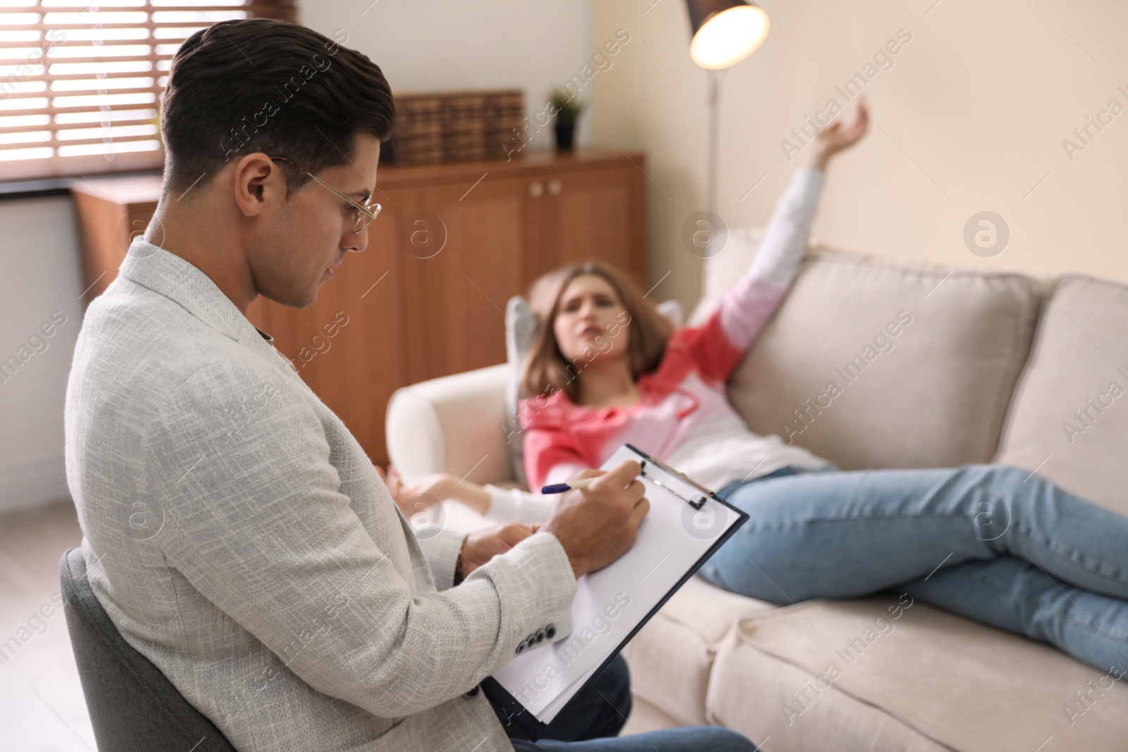 Photo of Professional psychotherapist working with patient in office