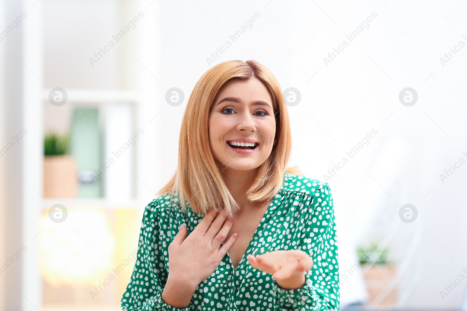 Photo of Beautiful woman using video chat for conversation indoors