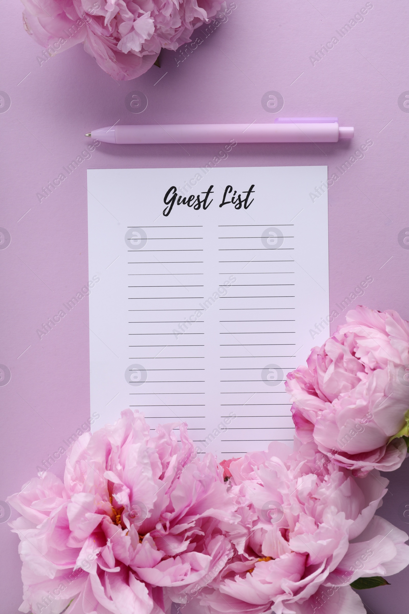 Photo of Guest list, pen and beautiful flowers on violet background, flat lay. Space for text