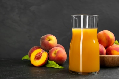 Photo of Natural freshly made peach juice on grey table