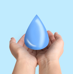 Image of Woman holding water drop on light blue background, closeup. Ecology protection