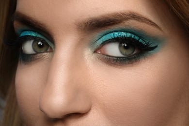 Young woman with evening makeup, closeup. Eye shadow product