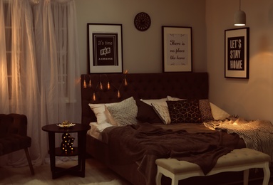 Stylish room interior with comfortable bed