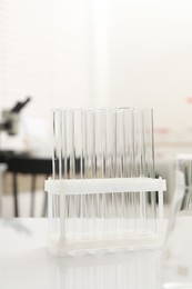 Laboratory analysis. Many test tubes on white table indoors