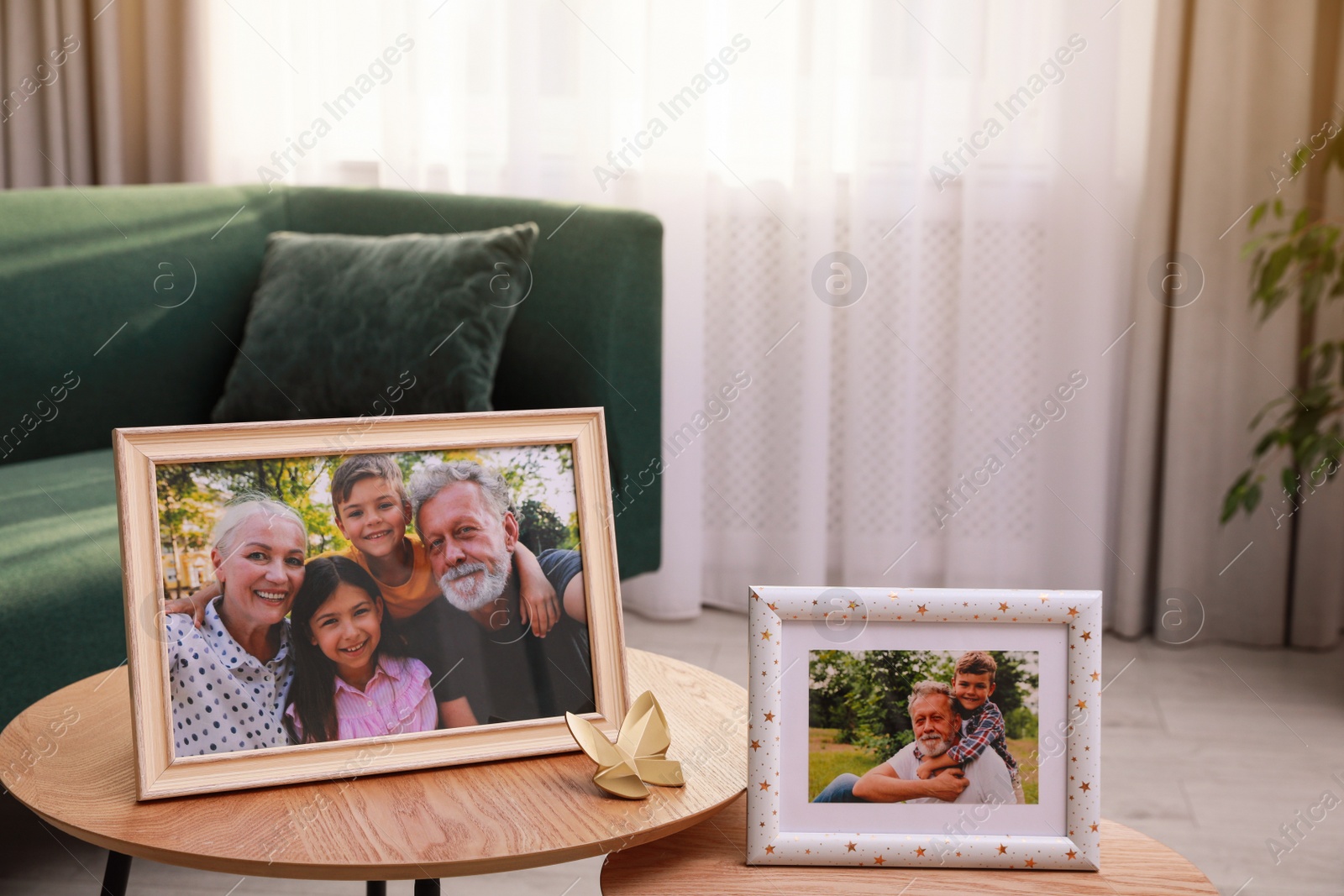 Photo of Framed family portraits in living room at home