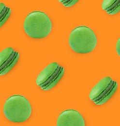 Delicious macarons on orange background, flat lay 