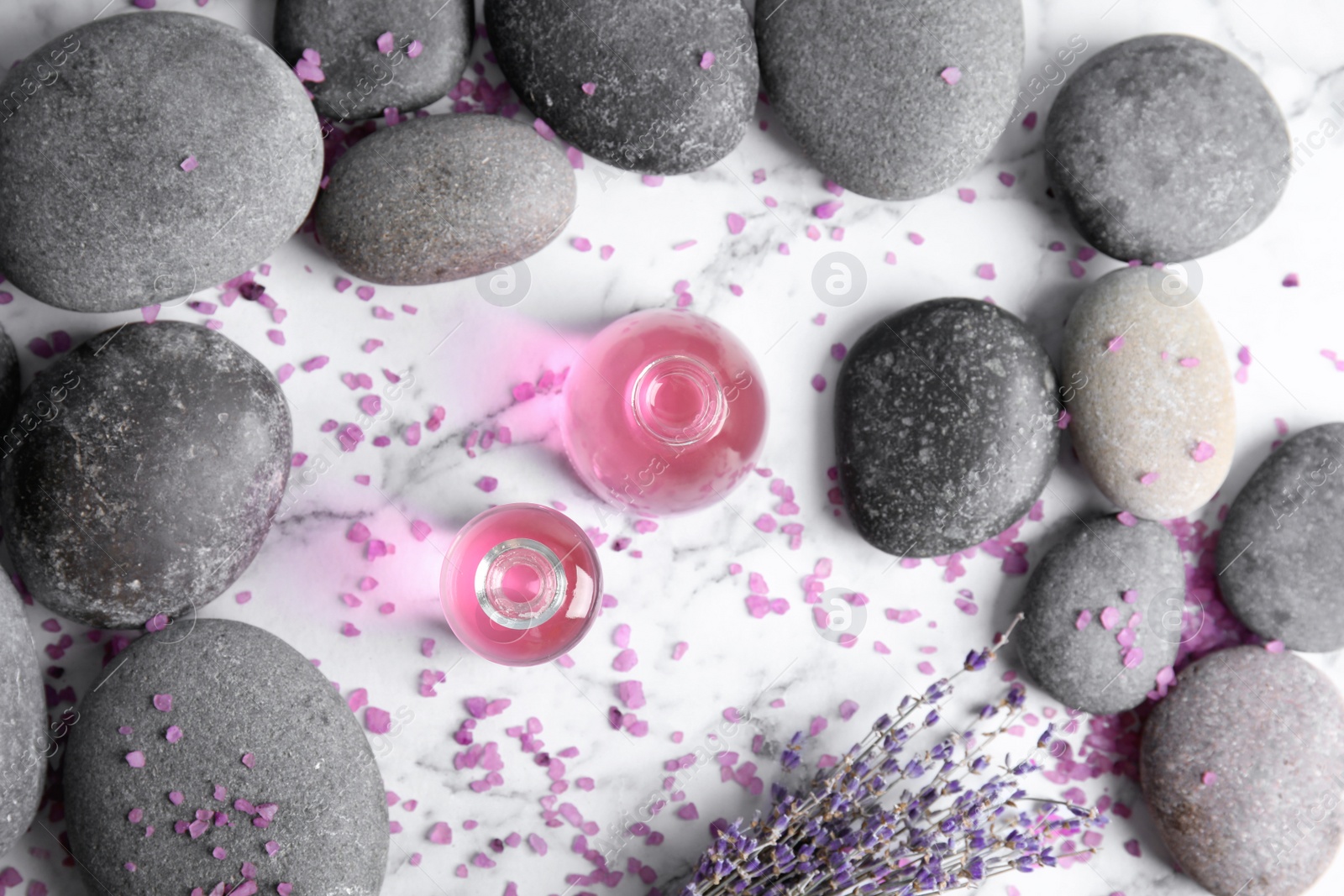 Photo of Flat lay composition with natural herbal oil and lavender flowers on marble background