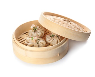 Bamboo steamer with tasty baozi dumplings on white background