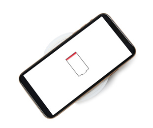 Mobile phone charging with wireless pad isolated on white, top view