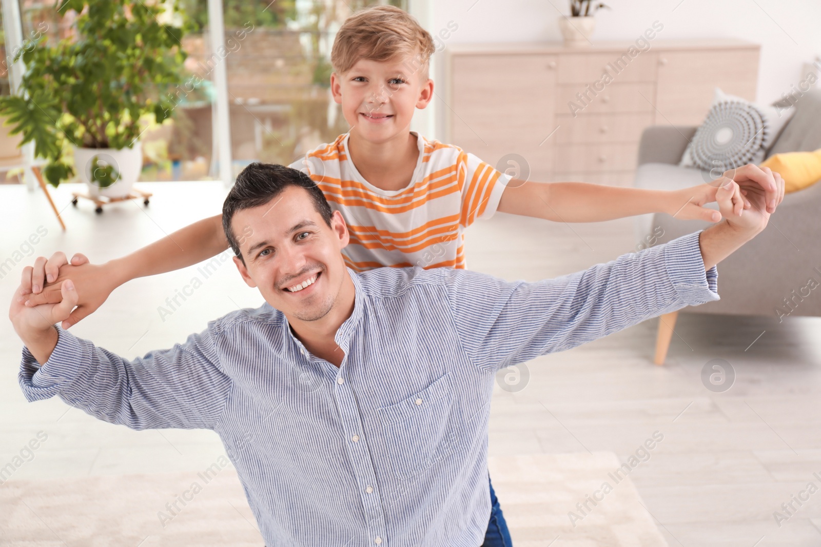 Photo of Father with cute child at home. Happy family