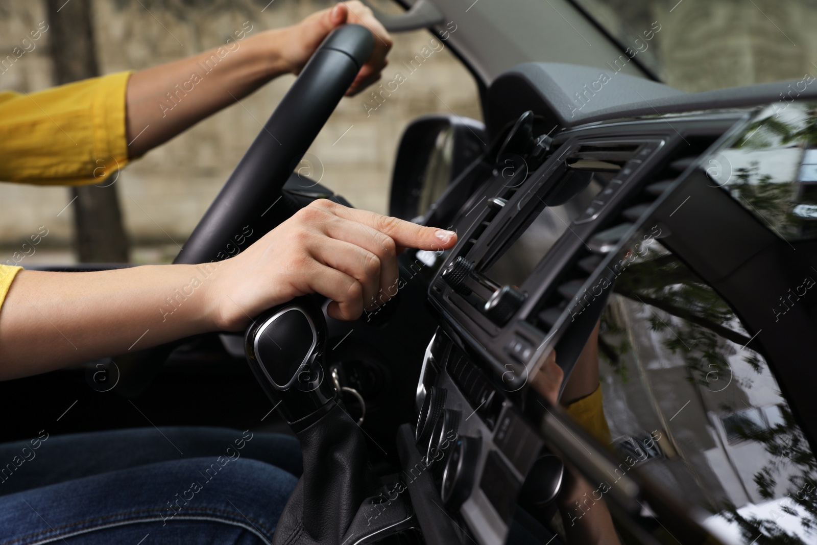 Photo of Woman using navigation system while driving car, closeup