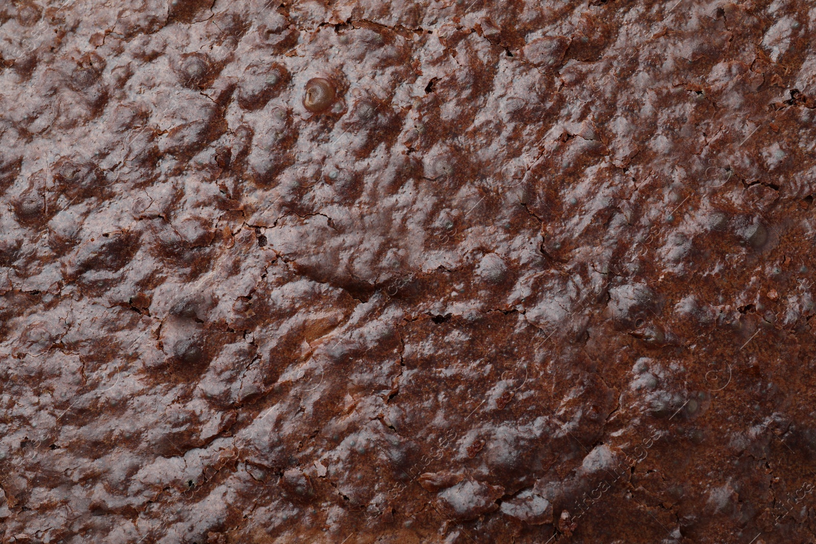 Photo of Closeup of delicious chocolate brownie as background, top view