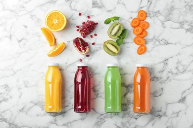 Photo of Flat lay composition with tasty juices and ingredients on marble background