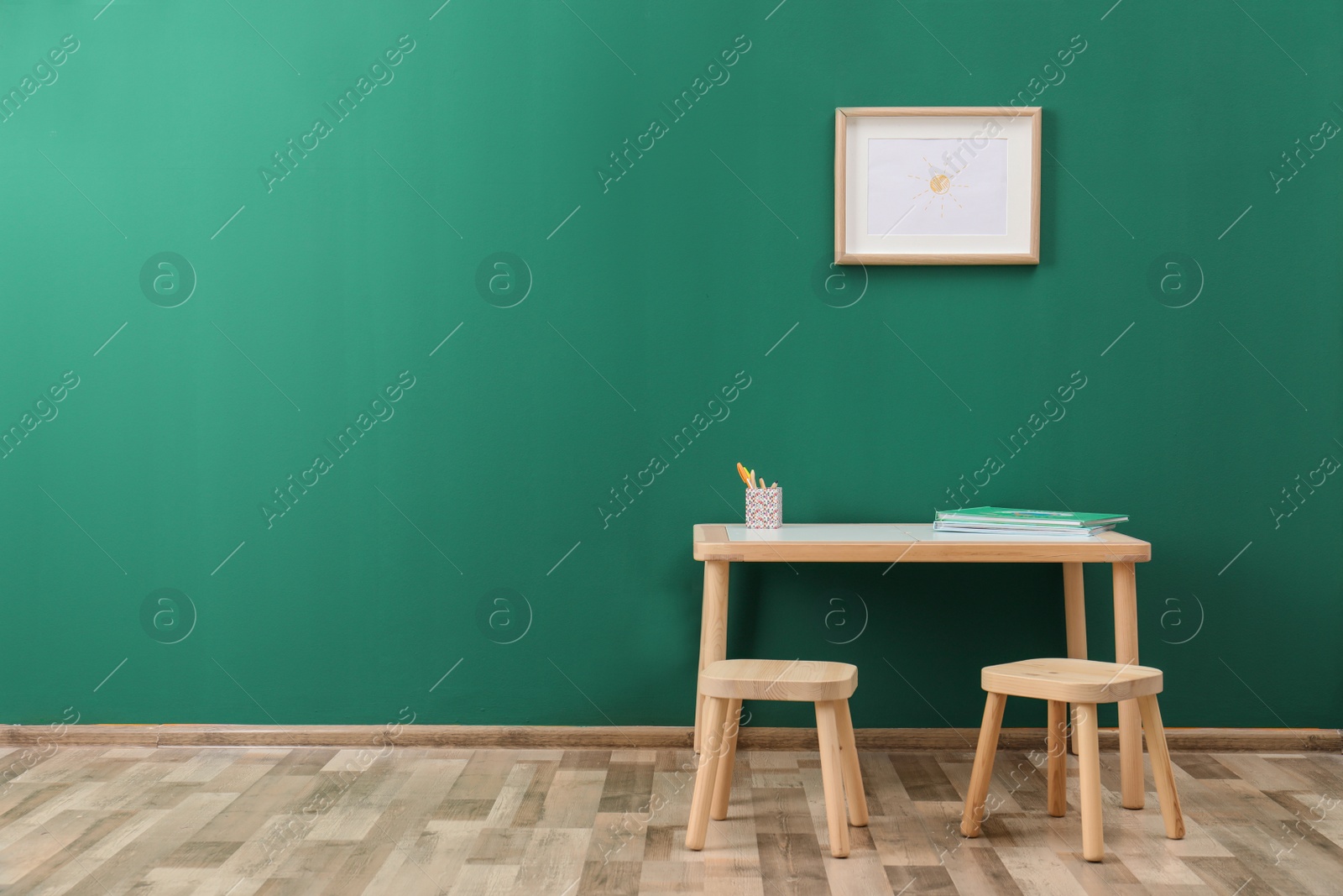 Photo of Table with stools in modern child room. Space for text