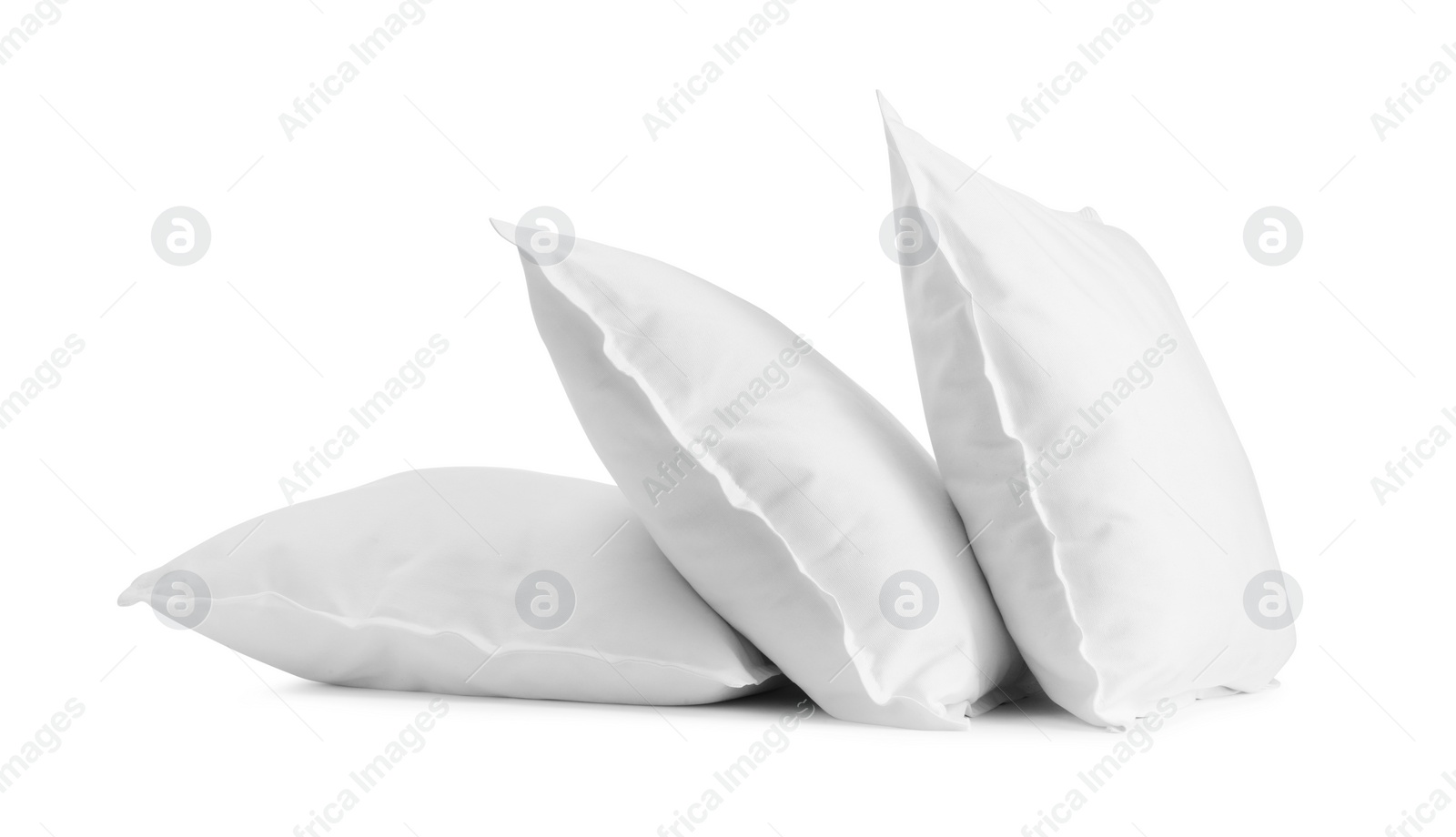 Photo of Three new soft pillows isolated on white